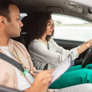 arabic instructor man conducting driving test for novice driver lady