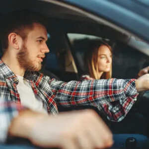 male instructor and woman student driving lesson