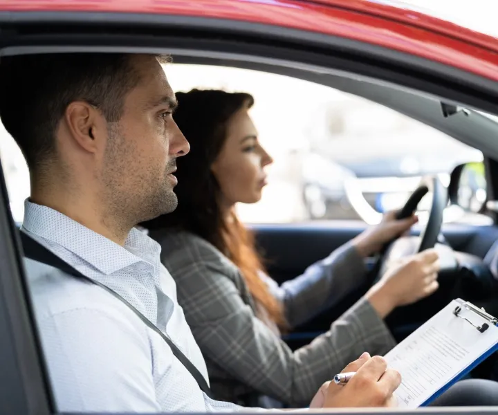 Instructor teaching a student driver